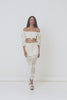 A studio video of model, Eden Bristowe, wearing the Spell Let The Sunshine In Crochet Skirt. The figure hugging skirt comes in a cream colourway and features a functional drawstring with tassels. 